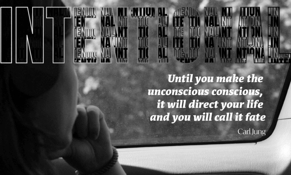 Woman gazing out car window with reflective Jung quote