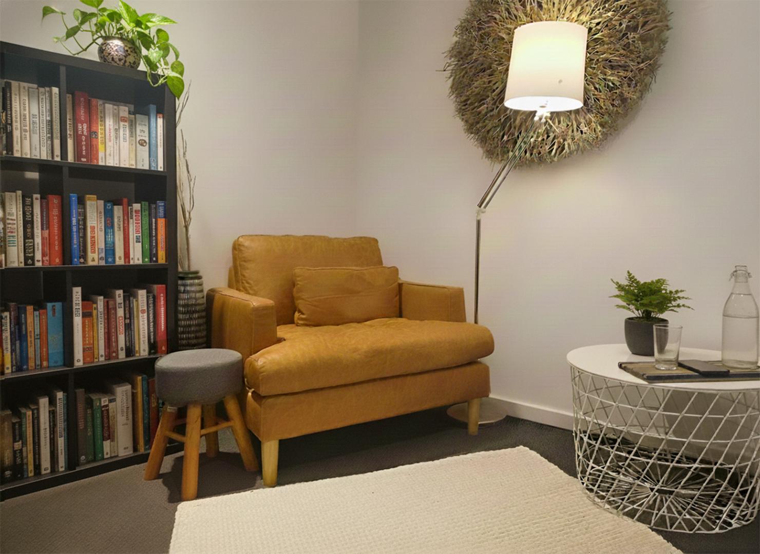 Cosy reading nook with chair and lamp.