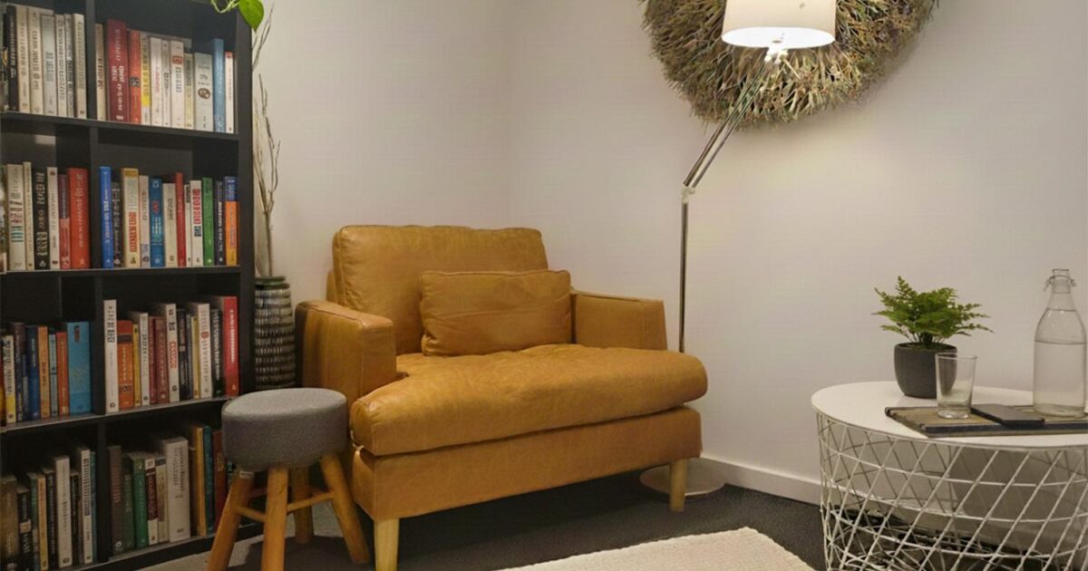 Cosy reading nook with chair and lamp.