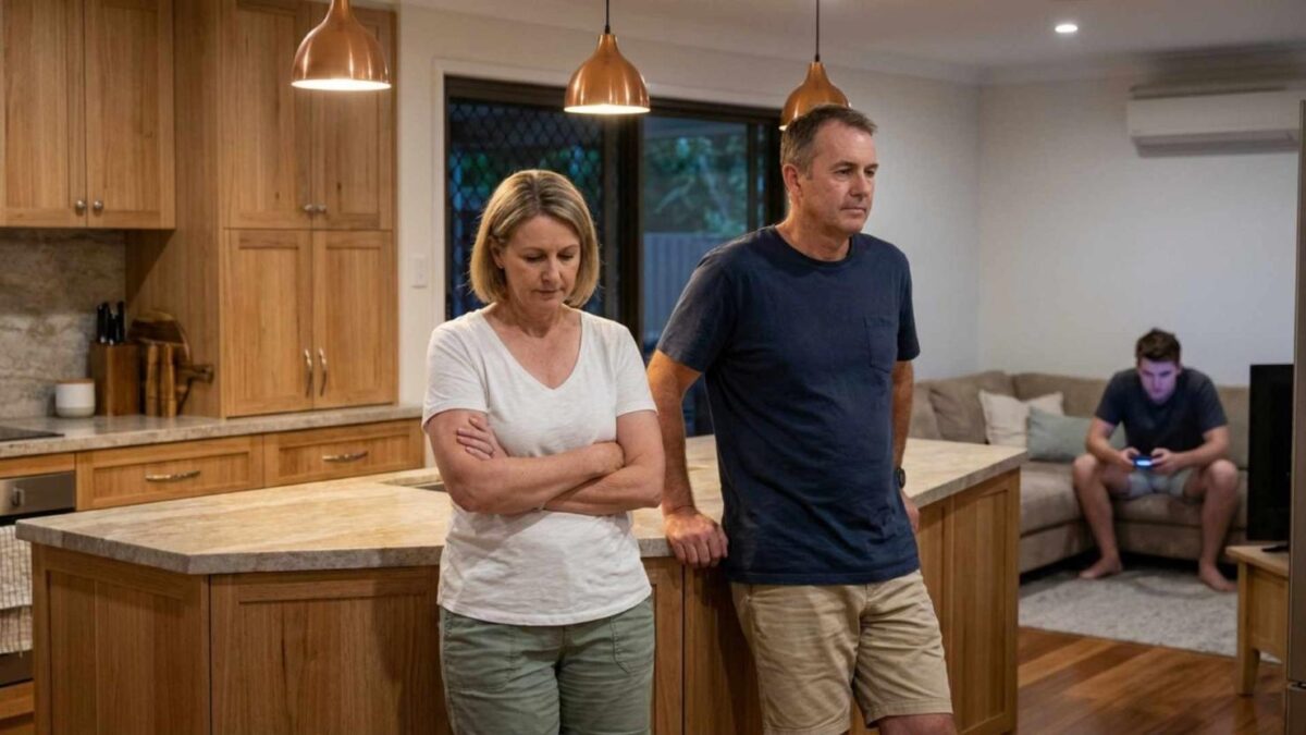 Family in kitchen, teenager playing video games.